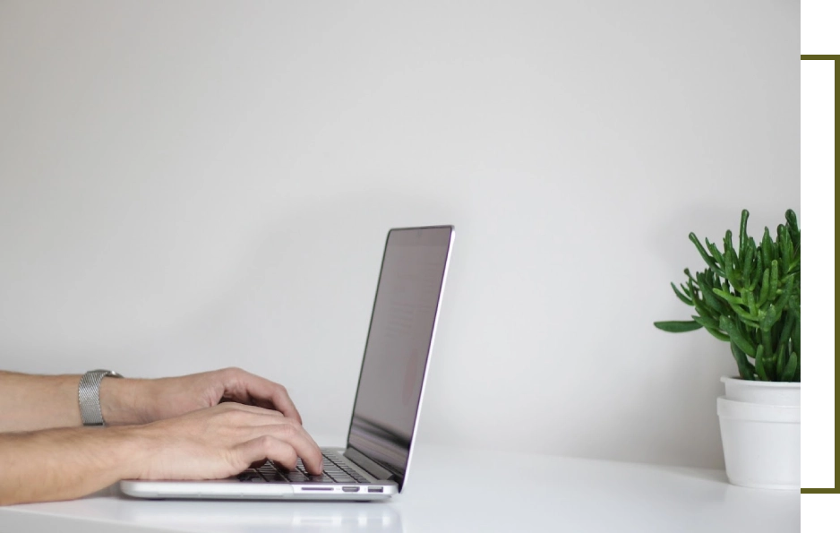 A person using their laptop on the table